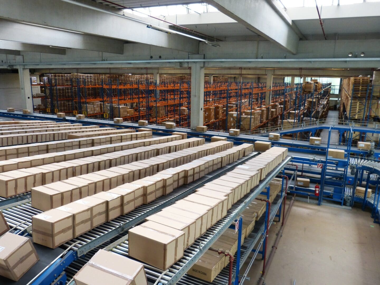 A warehouse filled with boxes and rows of racks.